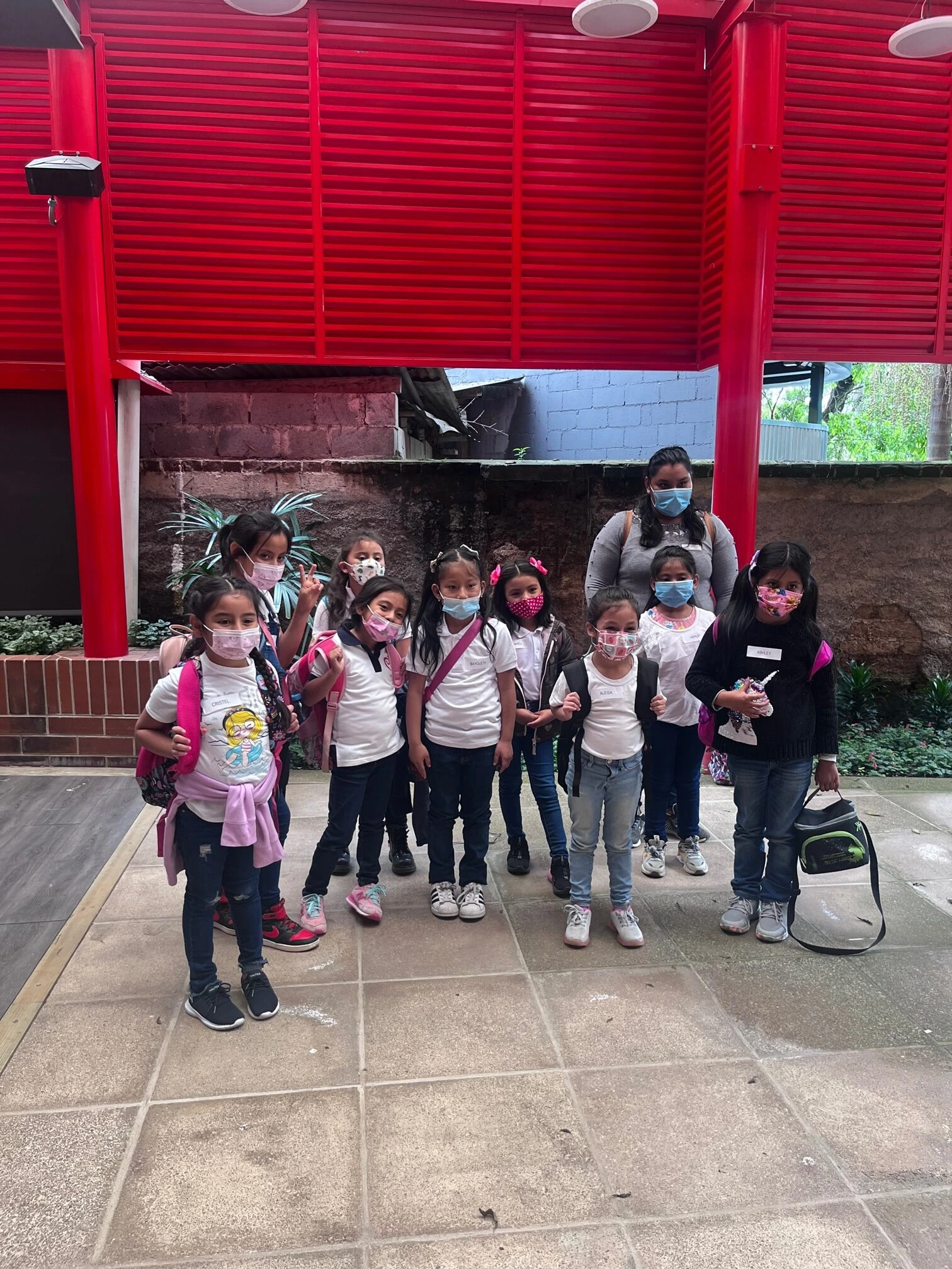 preventive dental care children A group of children and a woman wearing masks, possibly in a school setting, with a focus on
